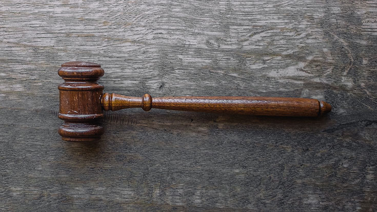 A gavel lying on a table.